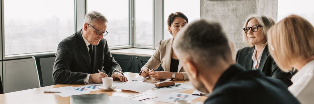 Business professionals engaged in a collaborative meeting around a conference table.